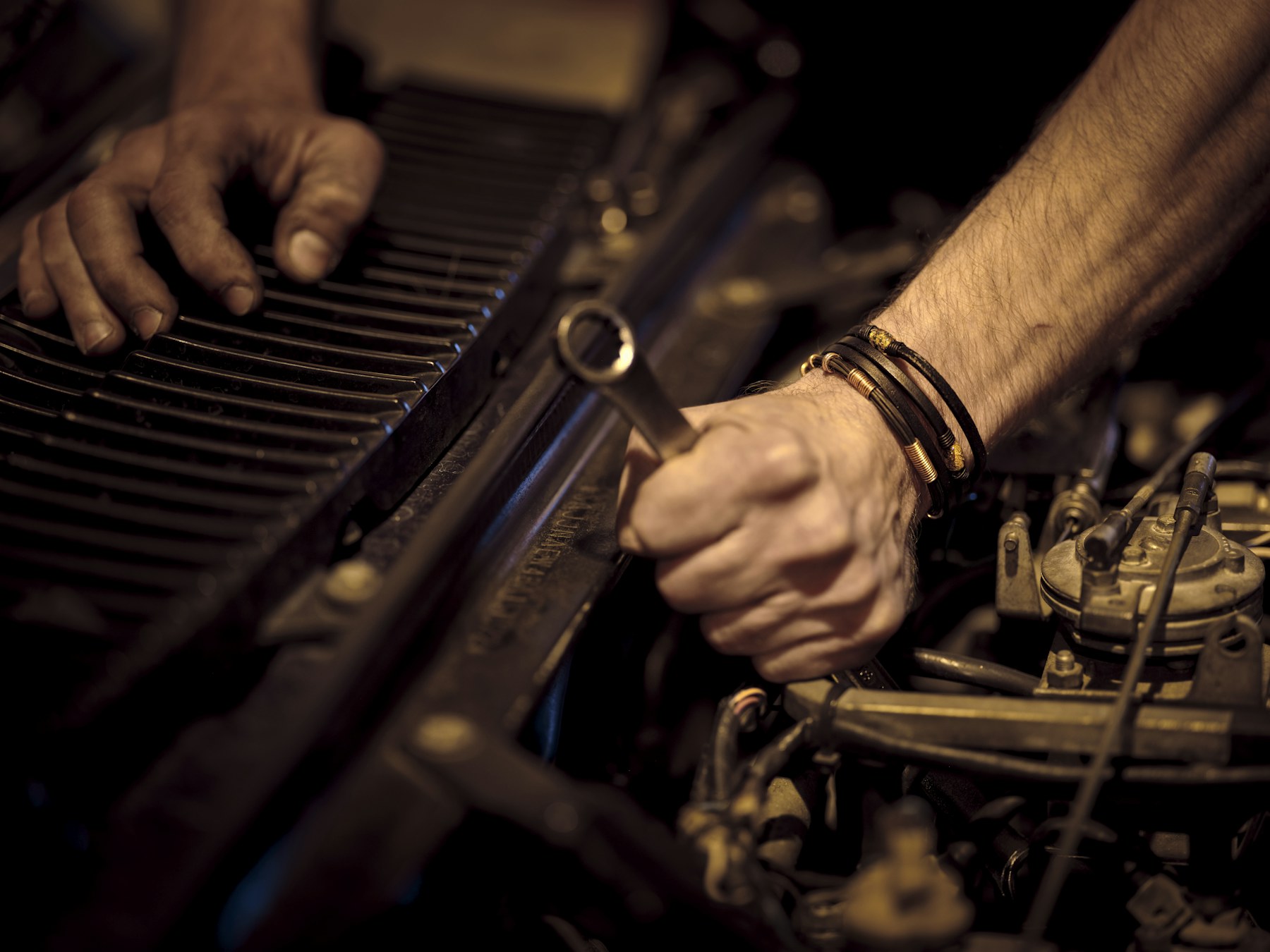 Technician working beneath a raised vehicle