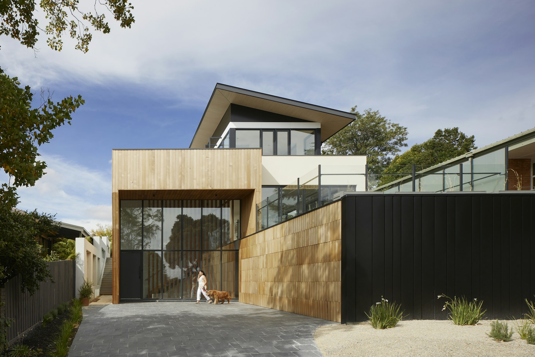 Contemporary residence with warm wood cladding and broad overhangs