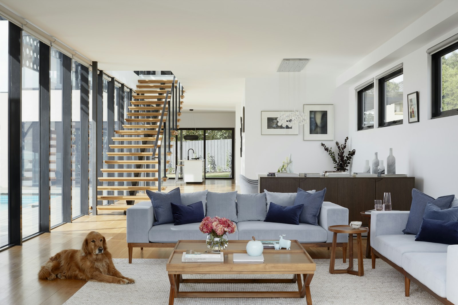 Light-filled living room with open stair and garden connection